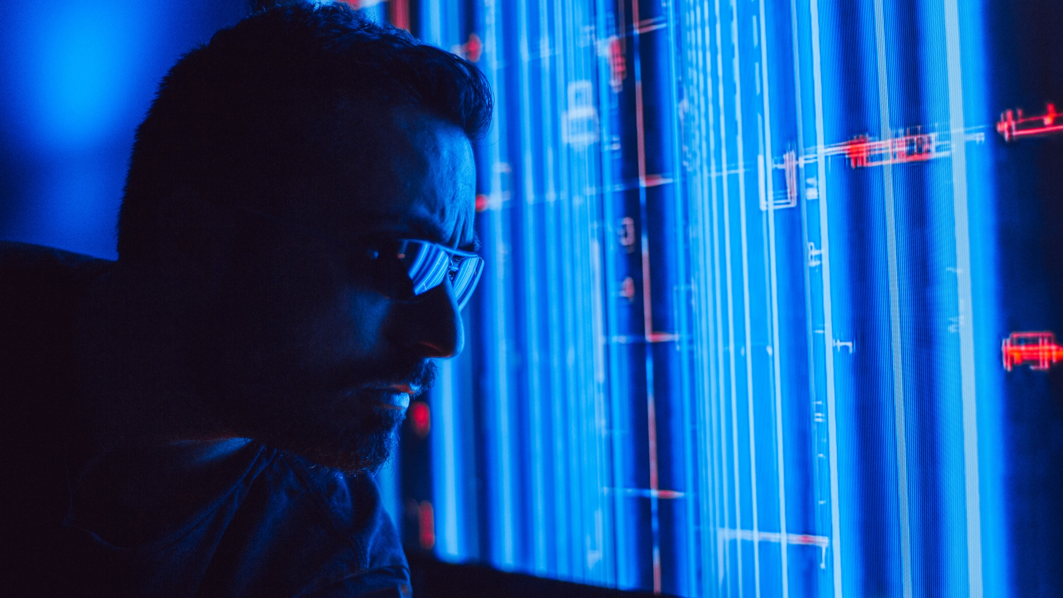 Person examining a glowing holographic interface, symbolizing artificial intelligence analysis and detection.